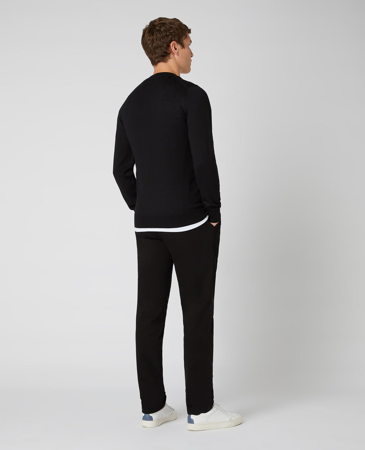 Man wearing a black Tapered Fit Merino Wool-Blend Crew Neck Sweater