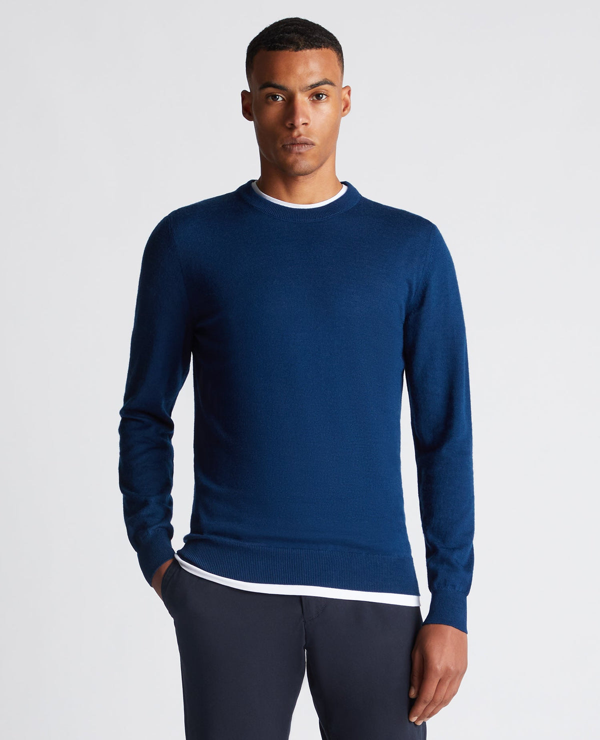 Man wearing a blue Tapered Fit Merino Wool-Blend Crew Neck Sweater