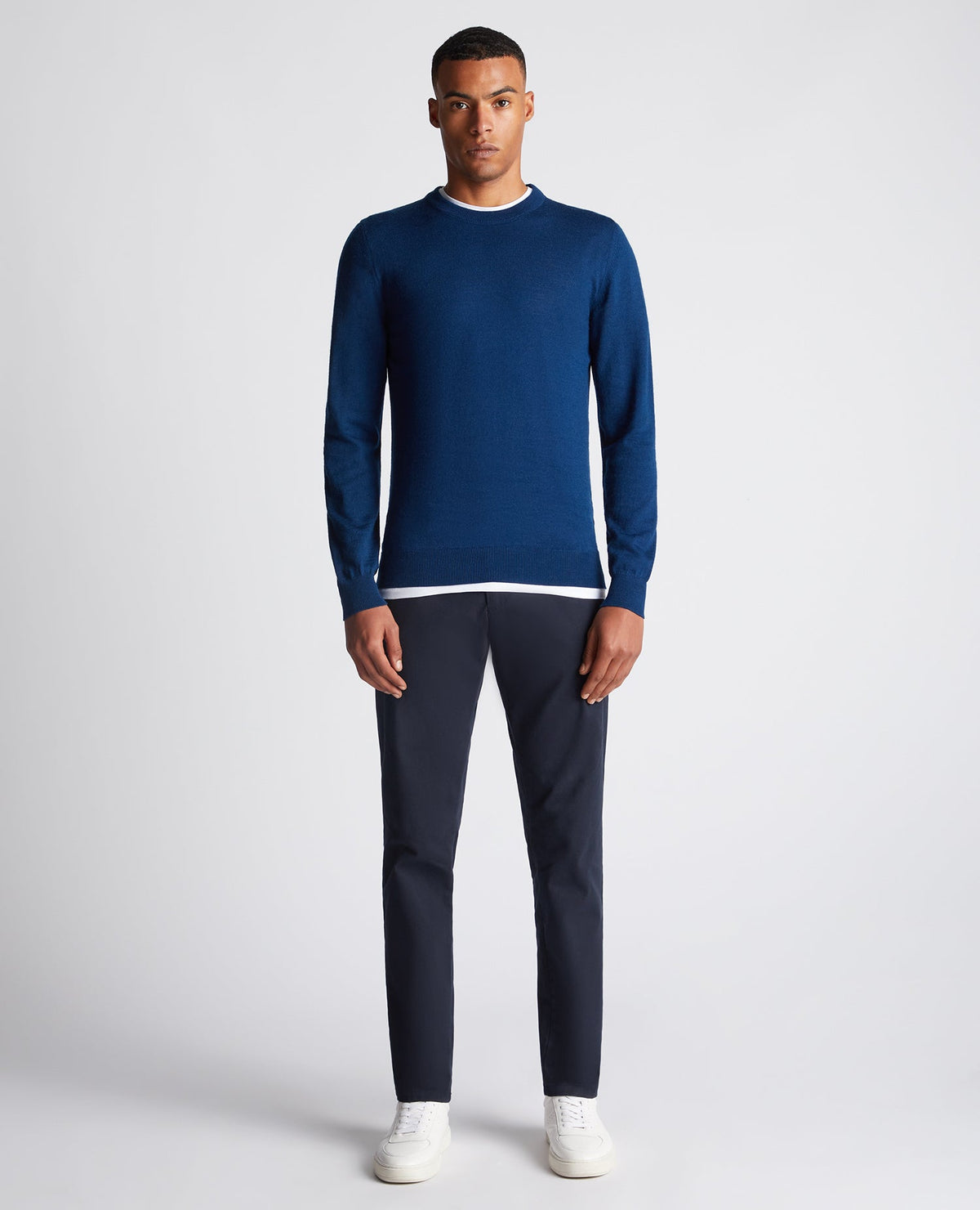 Man wearing a blue Tapered Fit Merino Wool-Blend Crew Neck Sweater