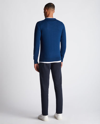 Man wearing a blue Tapered Fit Merino Wool-Blend Crew Neck Sweater