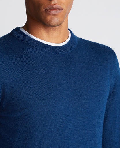 Man wearing a blue Tapered Fit Merino Wool-Blend Crew Neck Sweater