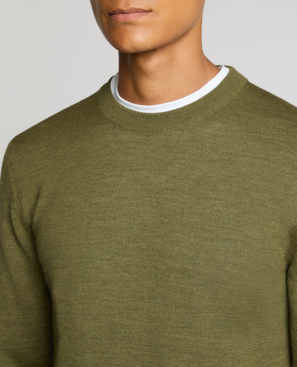 Man wearing a green Crew Neck Merino Wool-Blend Sweater