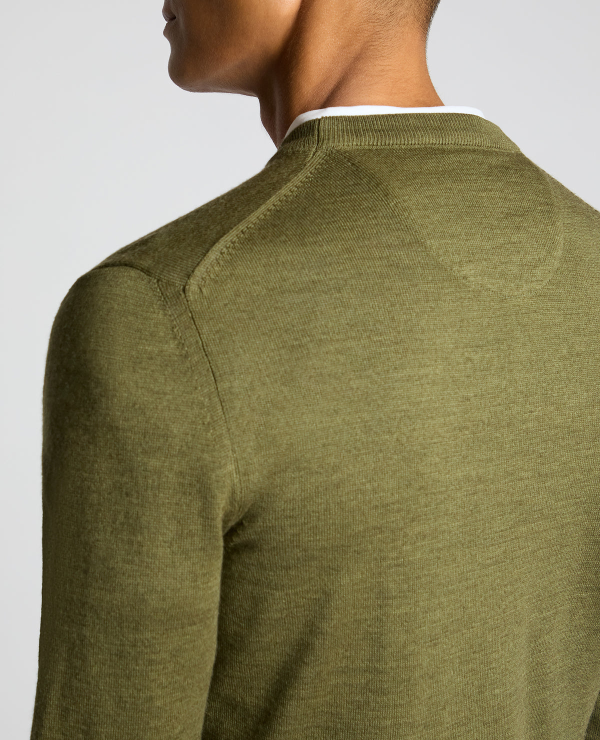 Man wearing a green Crew Neck Merino Wool-Blend Sweater