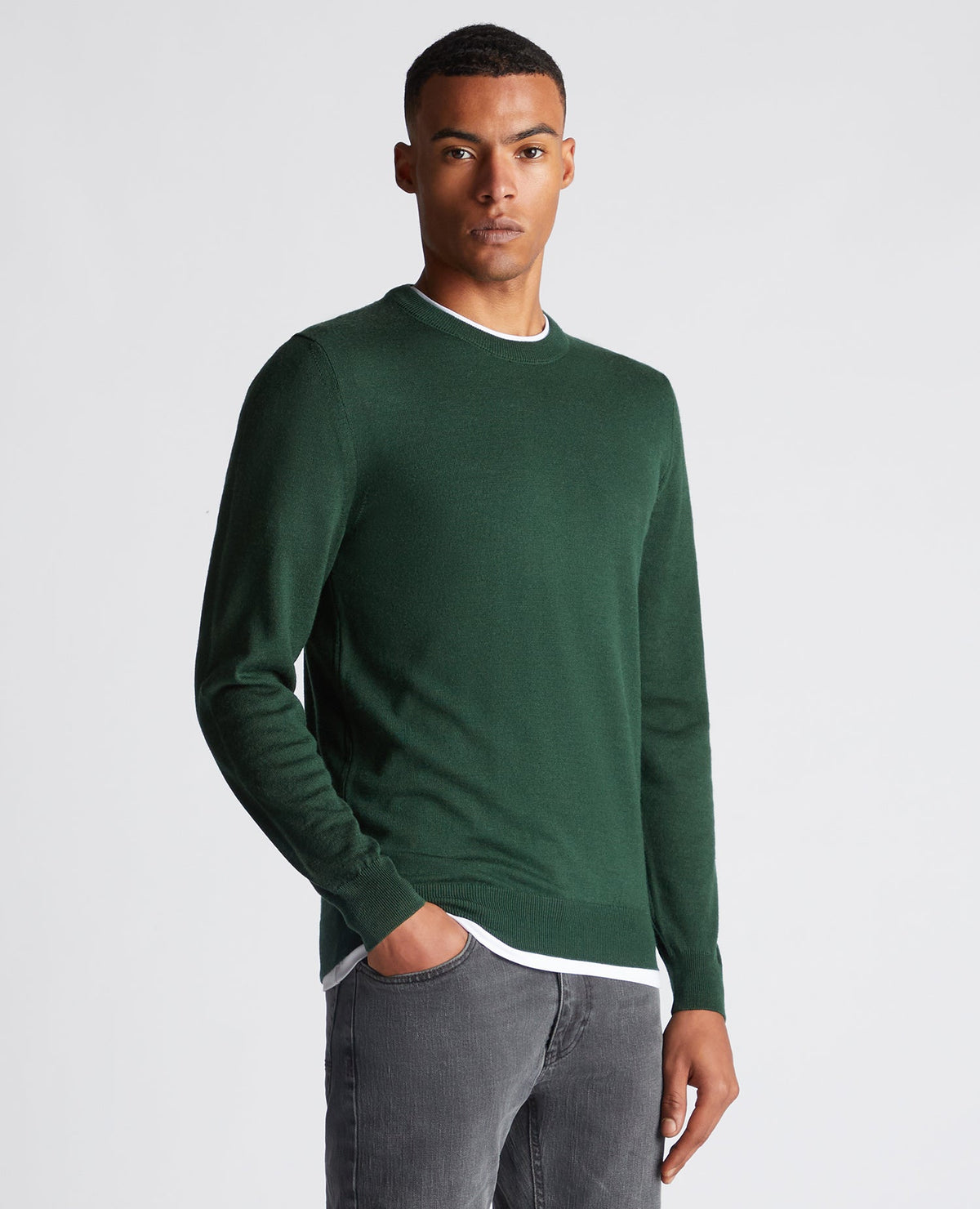 Man wearing a green Tapered Fit Merino Wool-Blend Crew Neck Sweater