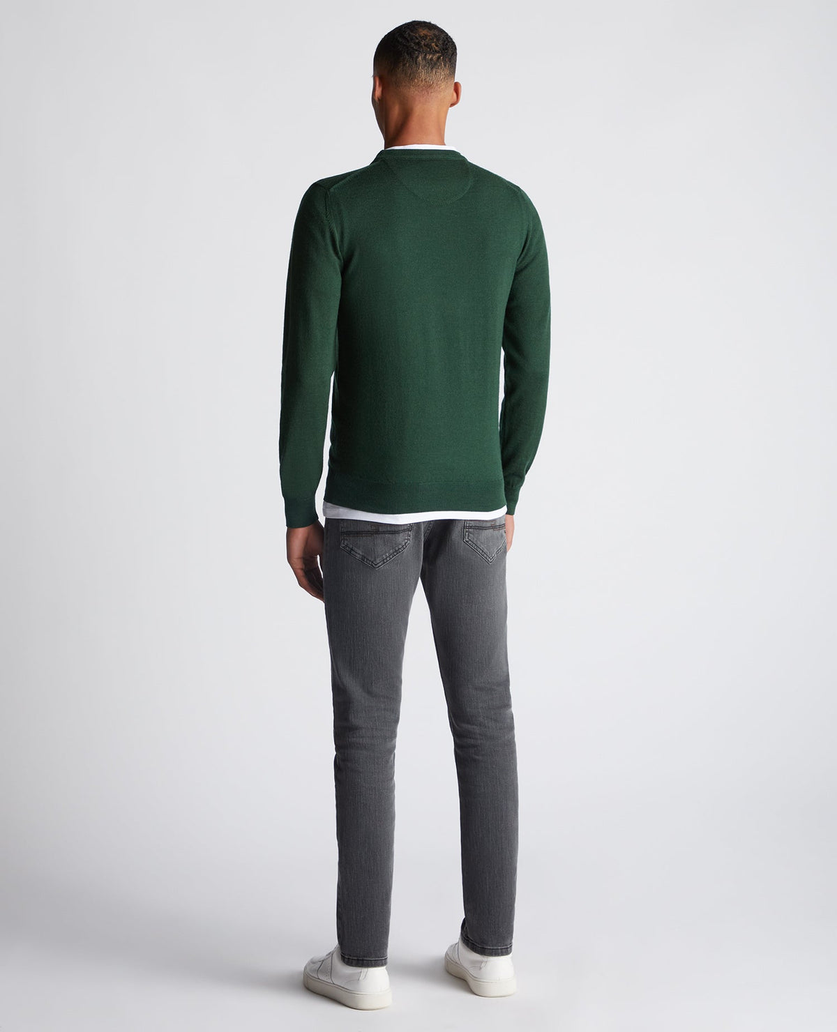 Man wearing a green Tapered Fit Merino Wool-Blend Crew Neck Sweater