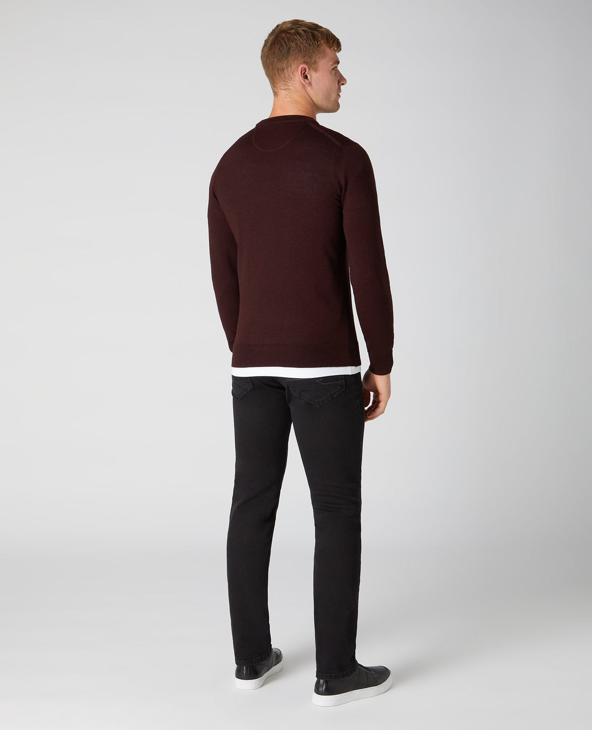 Man wearing a red Tapered Fit Merino Wool-Blend Crew Neck Sweater