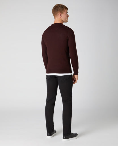 Man wearing a red Tapered Fit Merino Wool-Blend Crew Neck Sweater