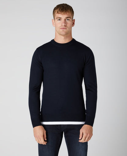 Man wearing a navy Tapered Fit Merino Wool-Blend Crew Neck Sweater