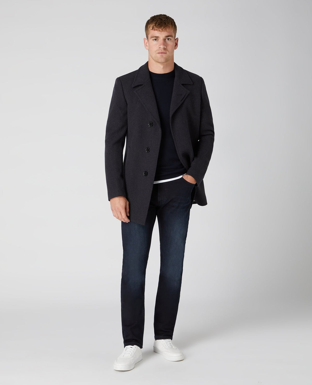 Man wearing a navy Tapered Fit Merino Wool-Blend Crew Neck Sweater