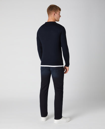 Man wearing a navy Tapered Fit Merino Wool-Blend Crew Neck Sweater