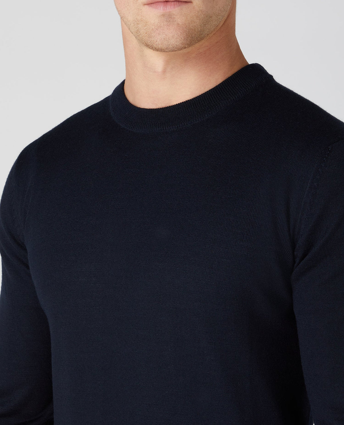 Man wearing a navy Tapered Fit Merino Wool-Blend Crew Neck Sweater