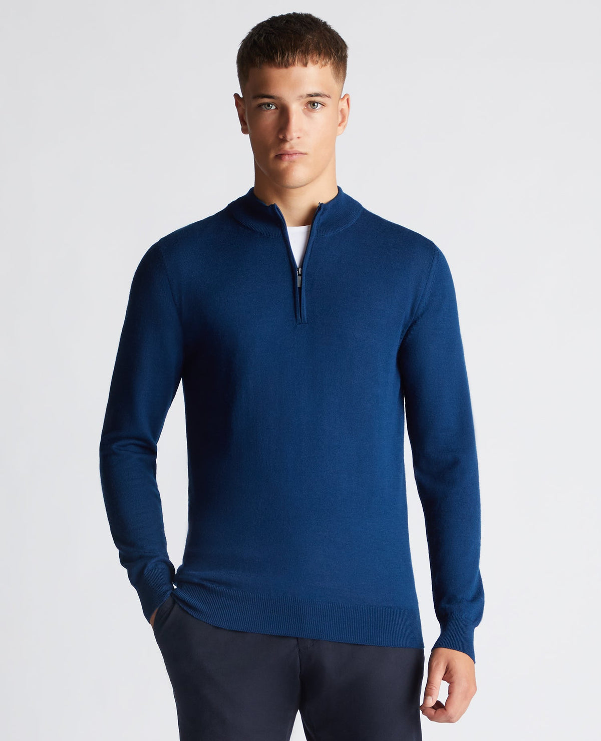 Man wearing a blue Tapered Fit Merino Wool-Blend Half Zip Sweater