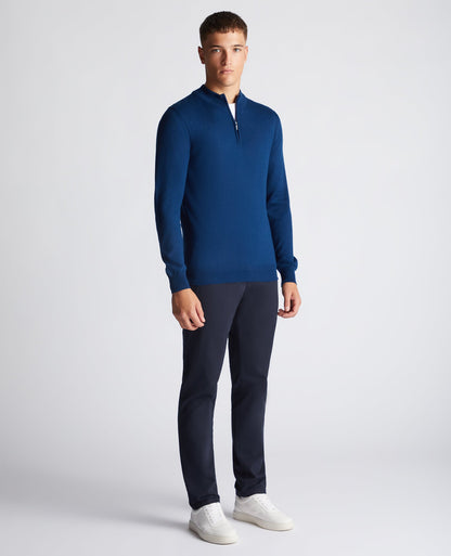 Man wearing a blue Tapered Fit Merino Wool-Blend Half Zip Sweater