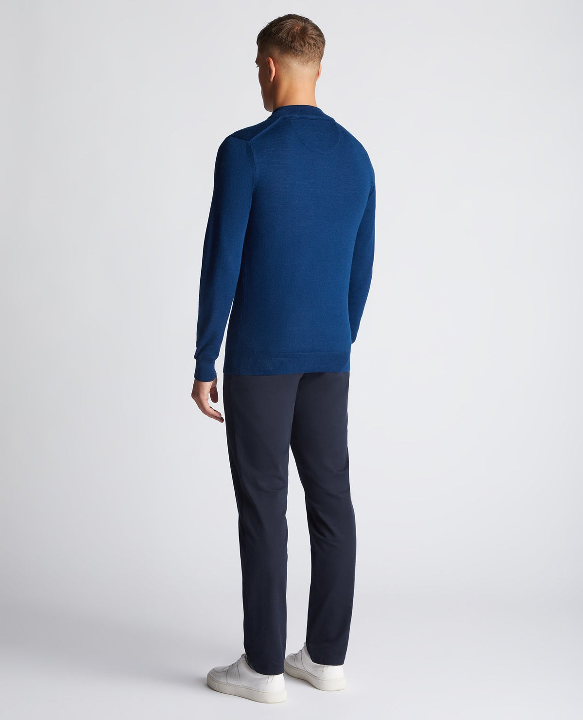 Man wearing a blue Tapered Fit Merino Wool-Blend Half Zip Sweater