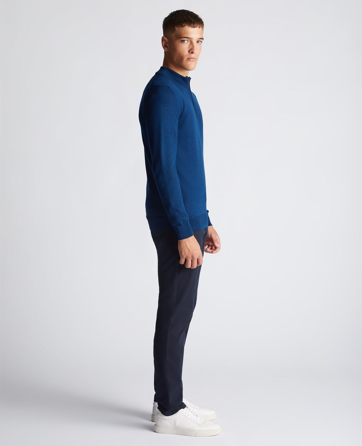 Man wearing a blue Tapered Fit Merino Wool-Blend Half Zip Sweater