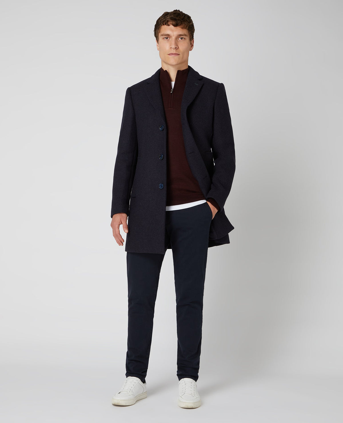 Man wearing a red Tapered Fit Merino Wool-Blend Half Zip Sweater