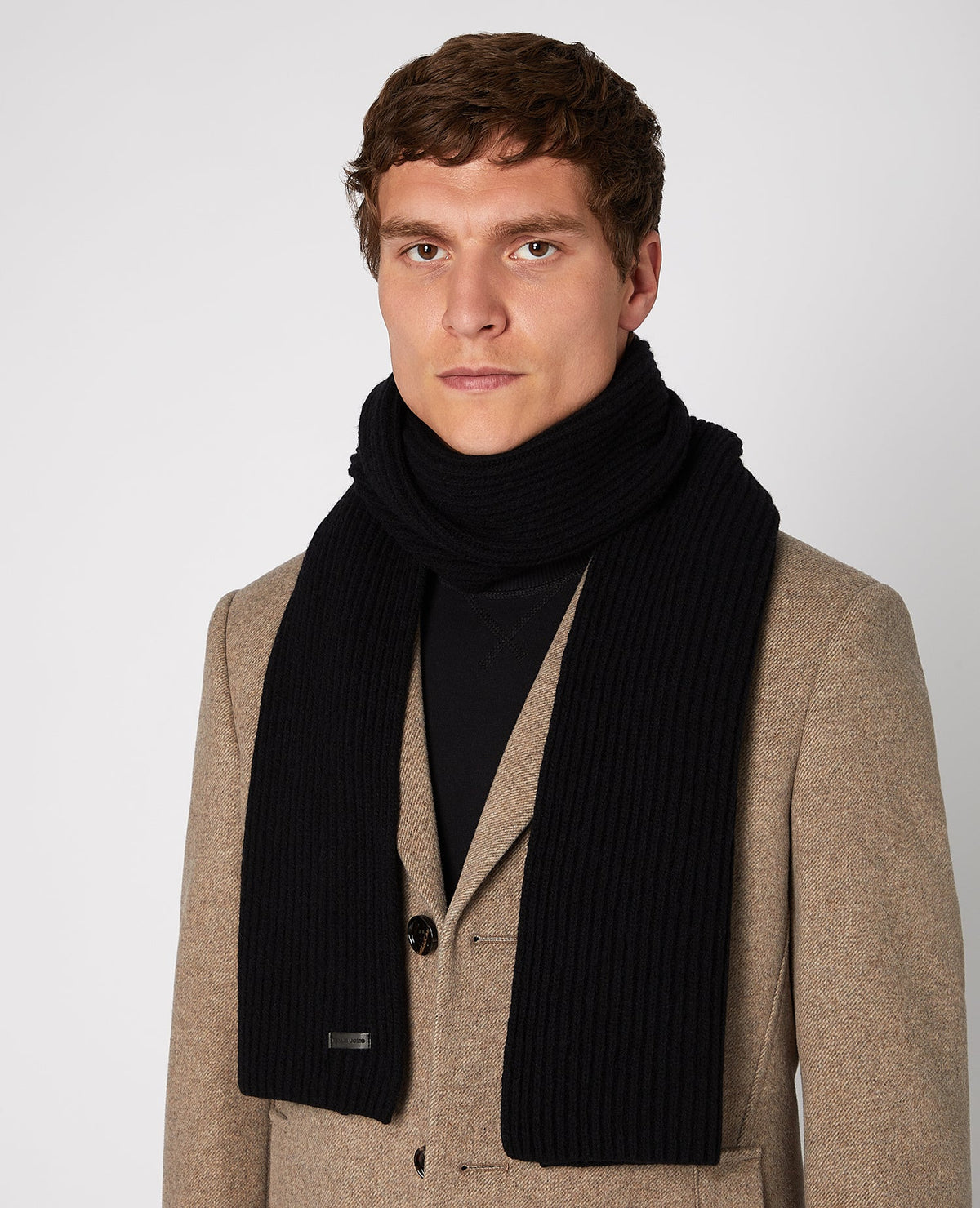 Man wearing a black Rib-Knit Wool Rich Scarf