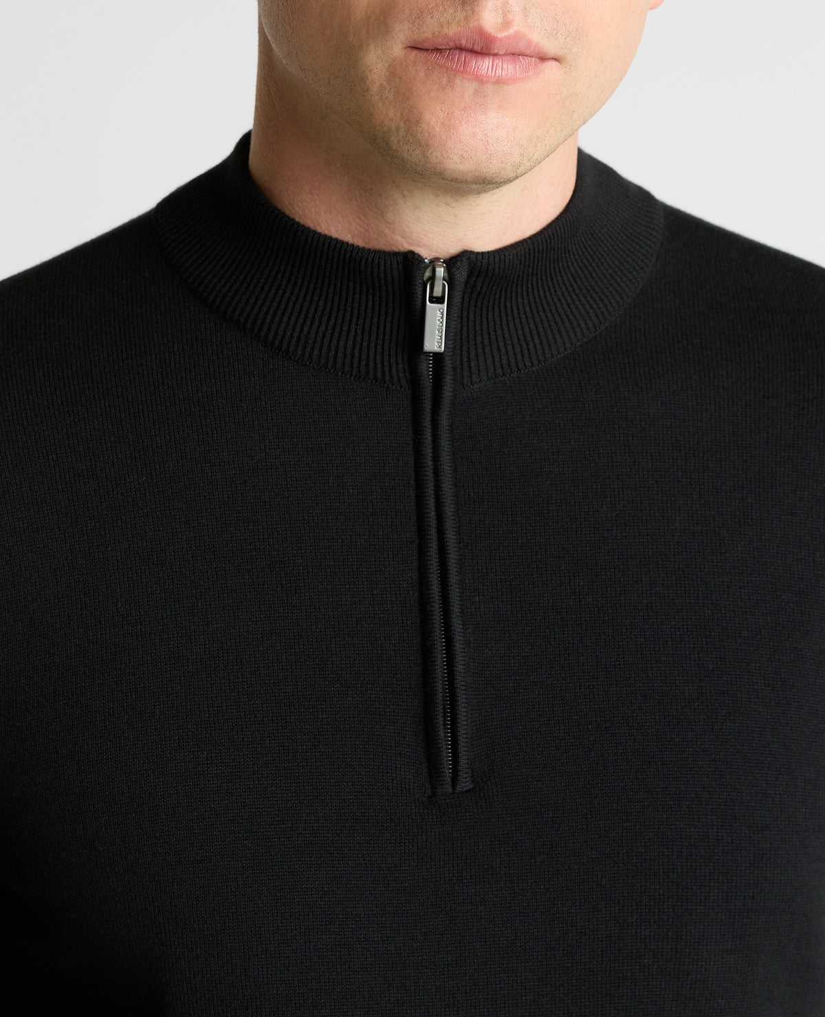Man wearing a black Half Zip Cotton Sweater
