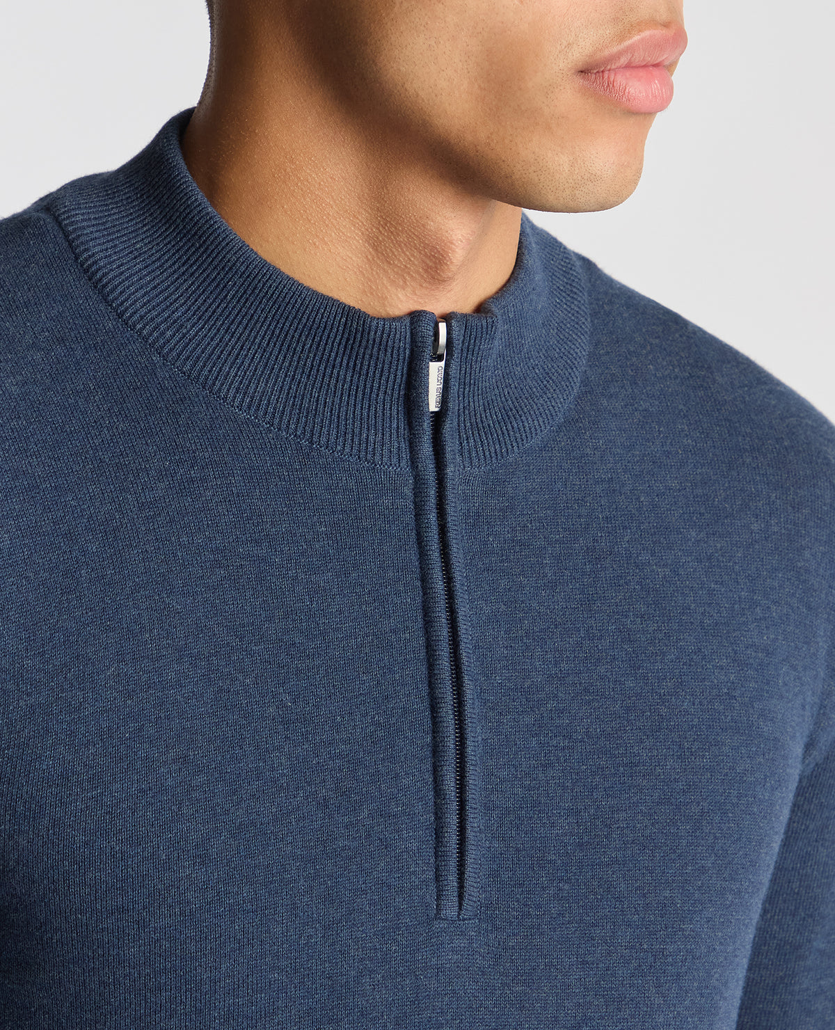 Man wearing a blue Tapered Fit Half Zip Cotton Sweater