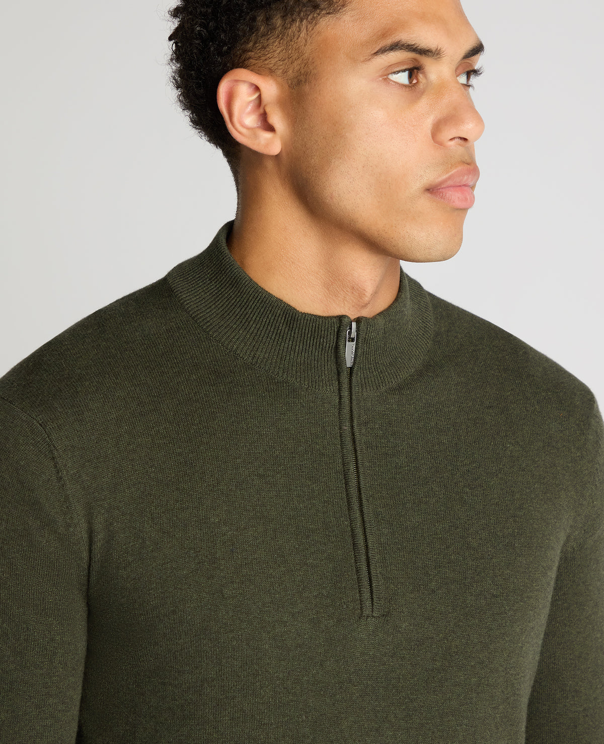 Man wearing a green Tapered Fit Half Zip Cotton Sweater