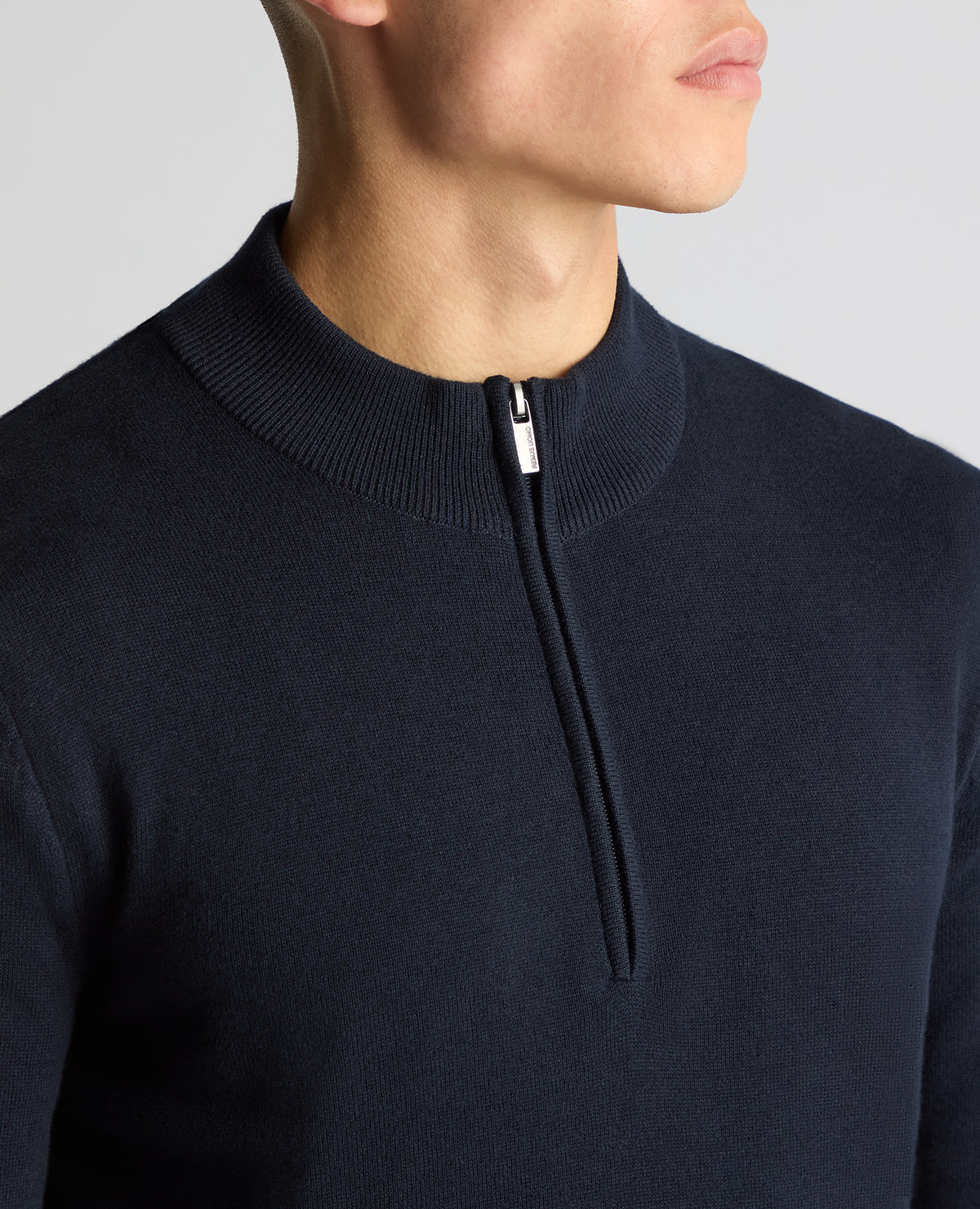 Man wearing a navy Tapered Fit Half Zip Cotton Sweater