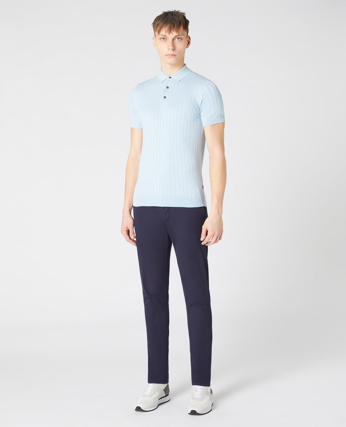 Man wearing a blue Slim Fit Knitted Cotton Short-Sleeve Polo Shirt