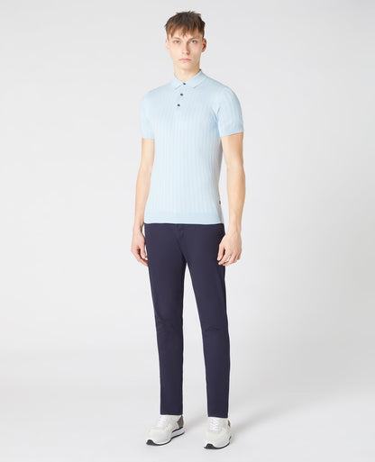 Man wearing a blue Slim Fit Knitted Cotton Short-Sleeve Polo Shirt