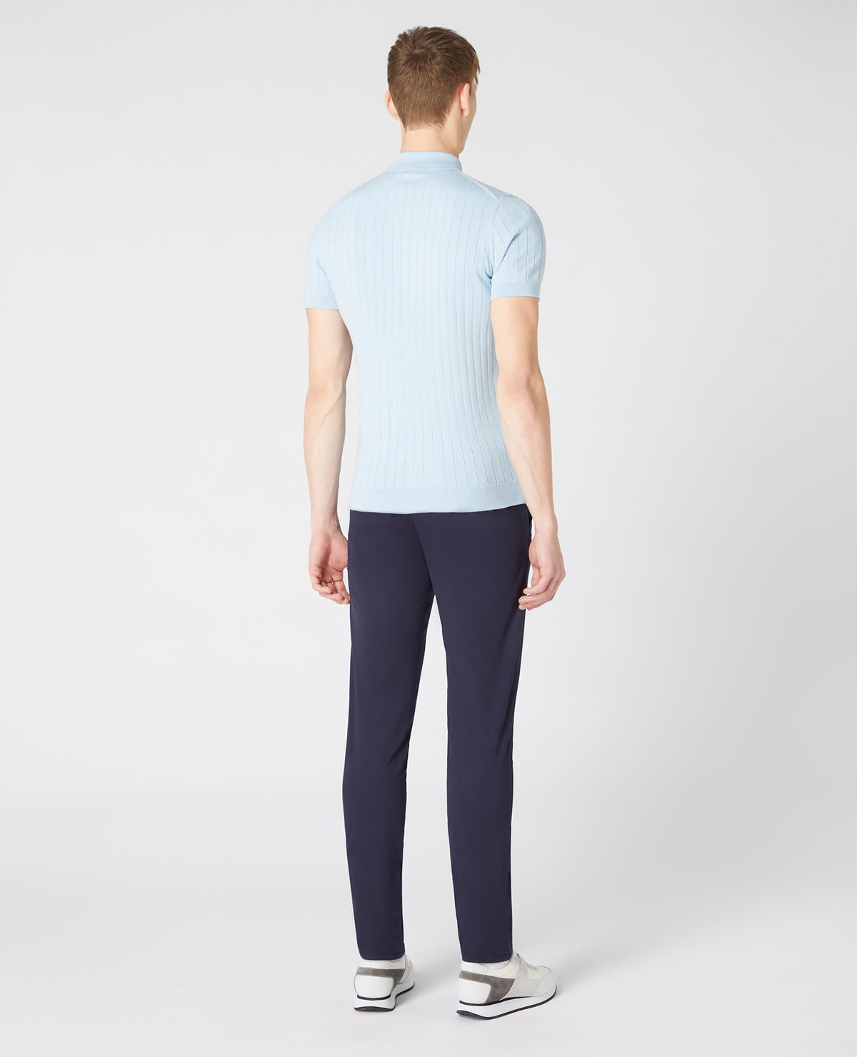 Man wearing a blue Slim Fit Knitted Cotton Short-Sleeve Polo Shirt