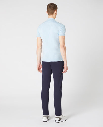 Man wearing a blue Slim Fit Knitted Cotton Short-Sleeve Polo Shirt