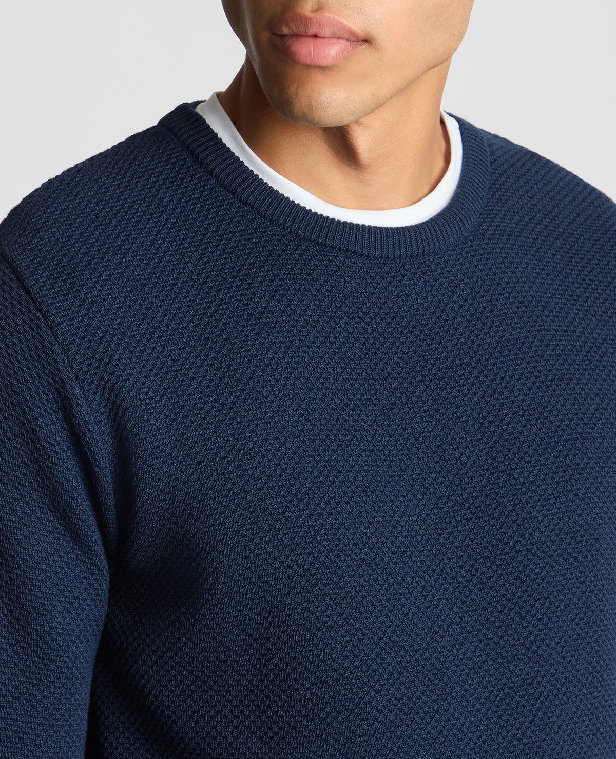 Man wearing a blue Tapered Fit Merino Wool-Blend Sweater