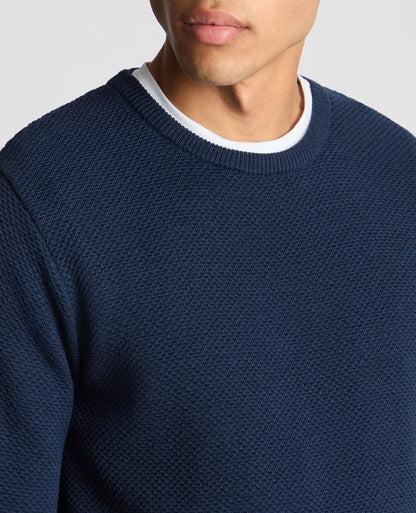 Man wearing a blue Tapered Fit Merino Wool-Blend Sweater