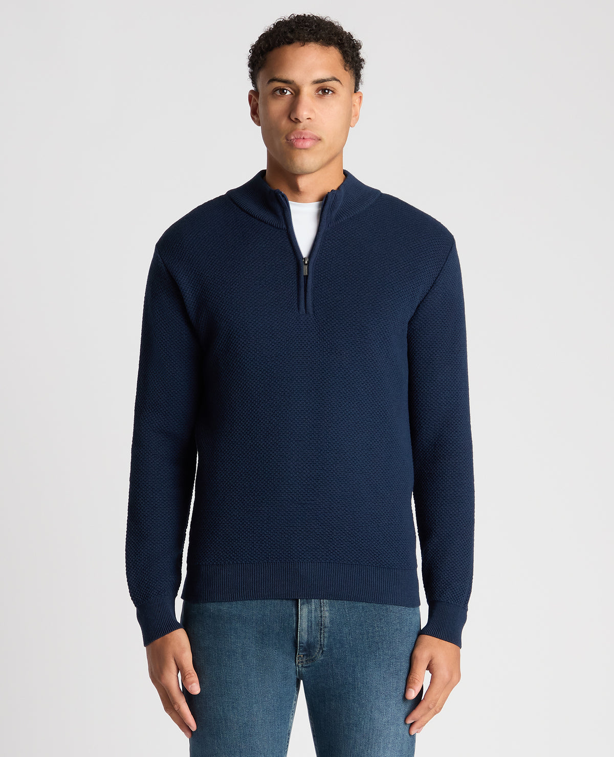 Man wearing a blue Tapered Fit Merino Half Zip Sweater