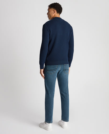 Man wearing a blue Tapered Fit Merino Half Zip Sweater