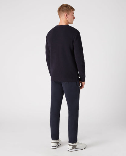 Man wearing a navy Tapered Fit Cotton-Rich Crew Neck Sweater