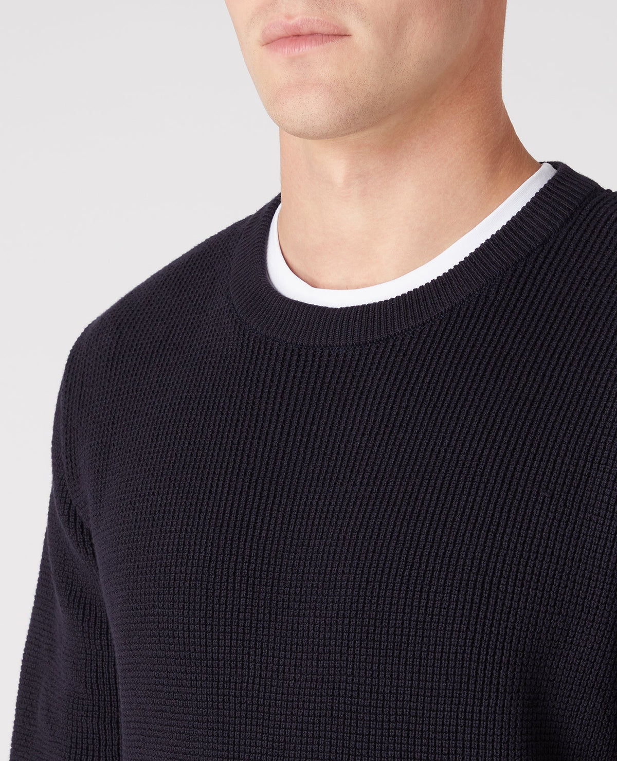 Man wearing a navy Tapered Fit Cotton-Rich Crew Neck Sweater