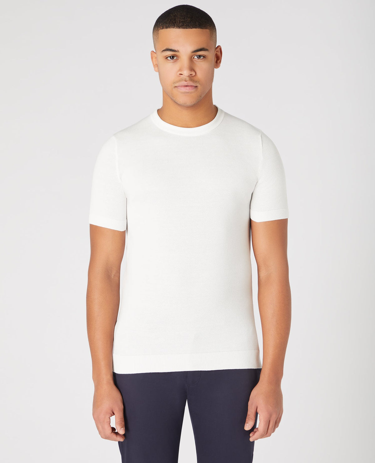 Man wearing a white Slim Fit Knitted Cotton Crew Neck Tee