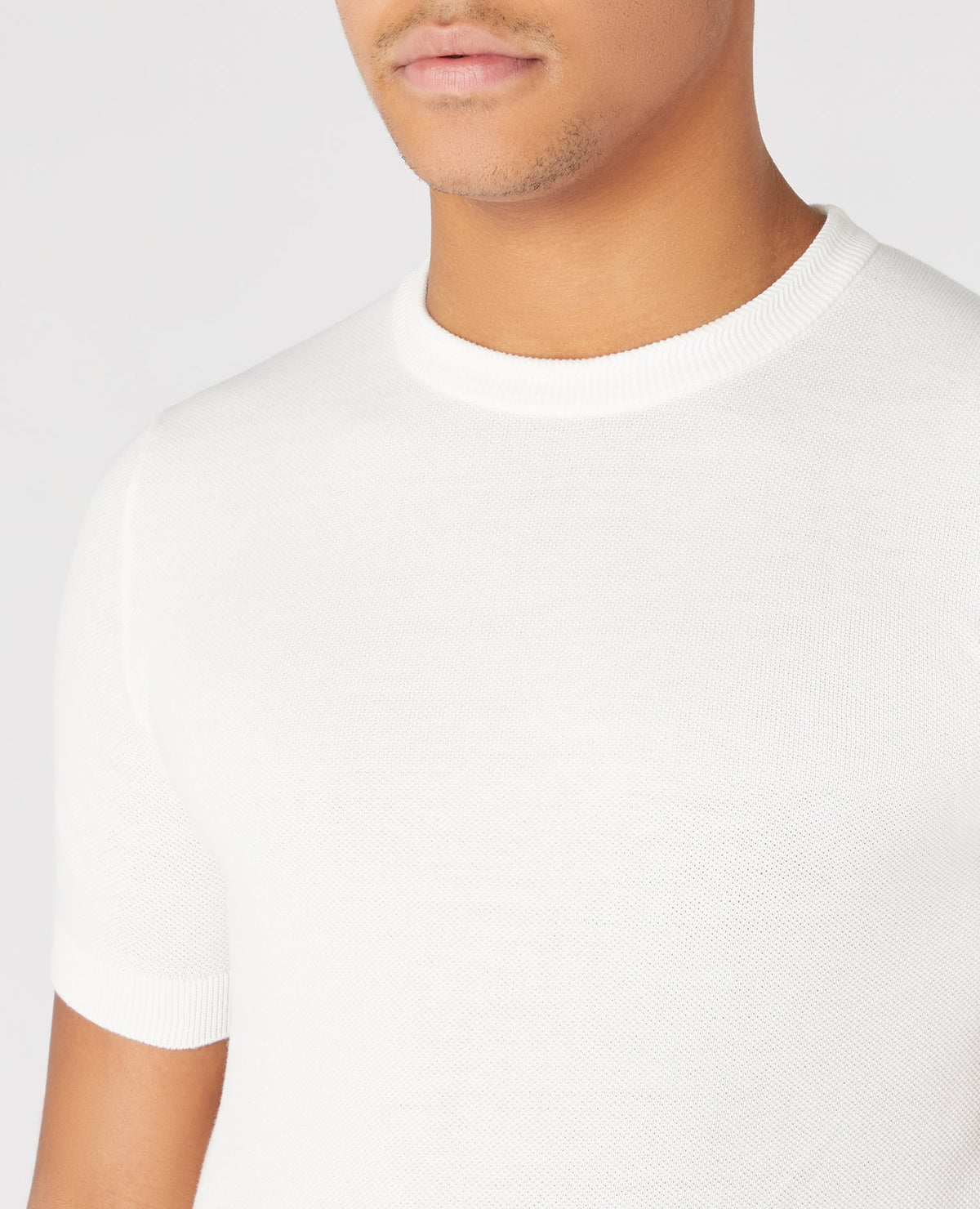 Man wearing a white Slim Fit Knitted Cotton Crew Neck Tee
