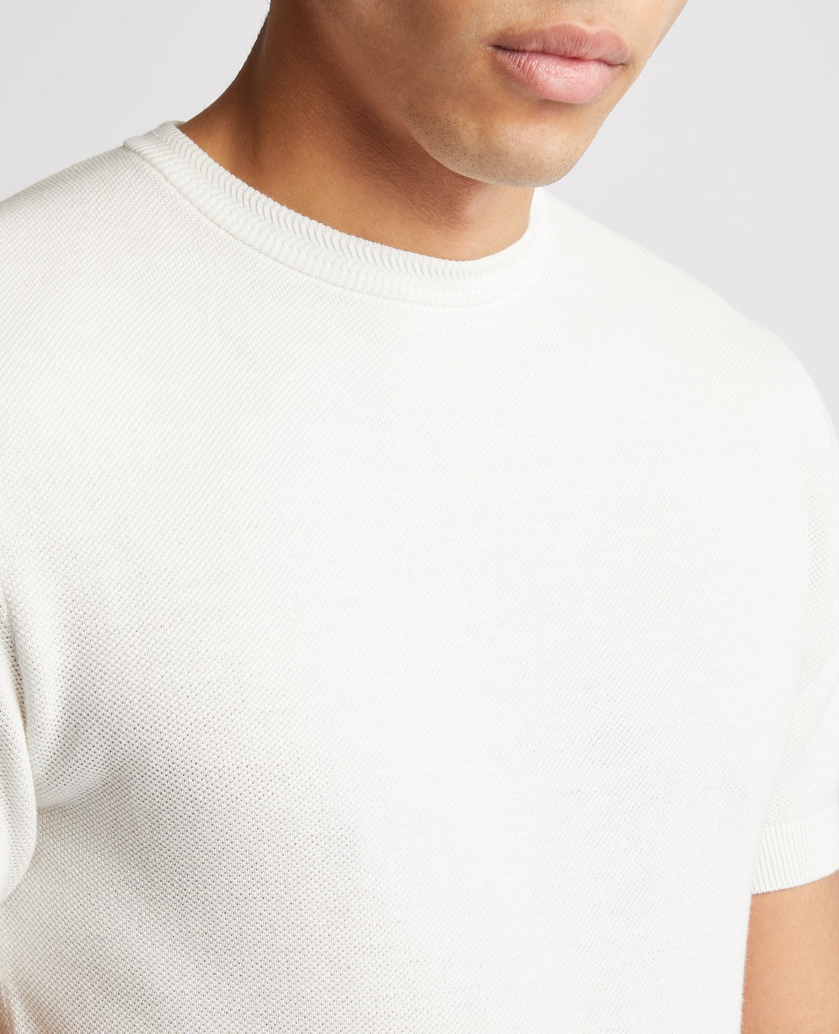 Man wearing a white Slim Fit Knitted Cotton Crew Neck Tee