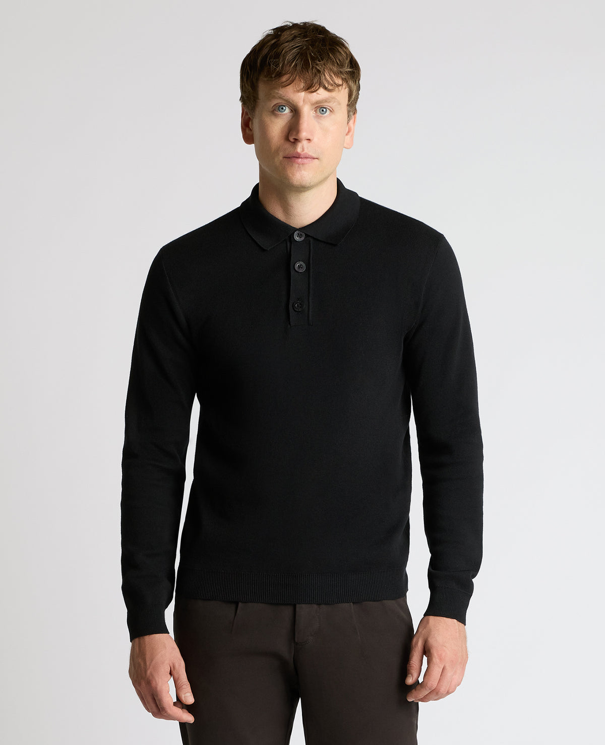Man wearing a black Long Sleeve Cotton Knit Polo