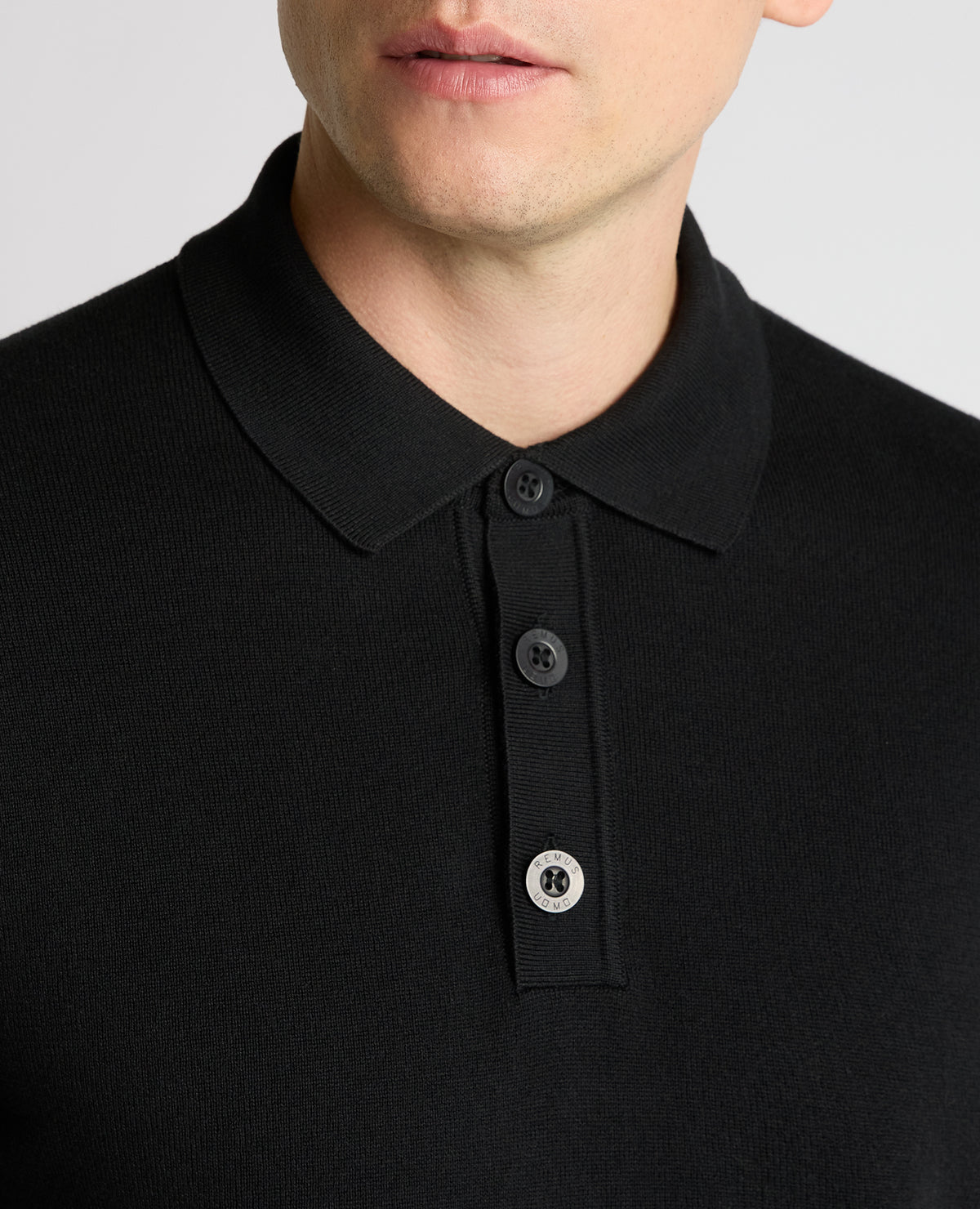 Man wearing a black Long Sleeve Cotton Knit Polo