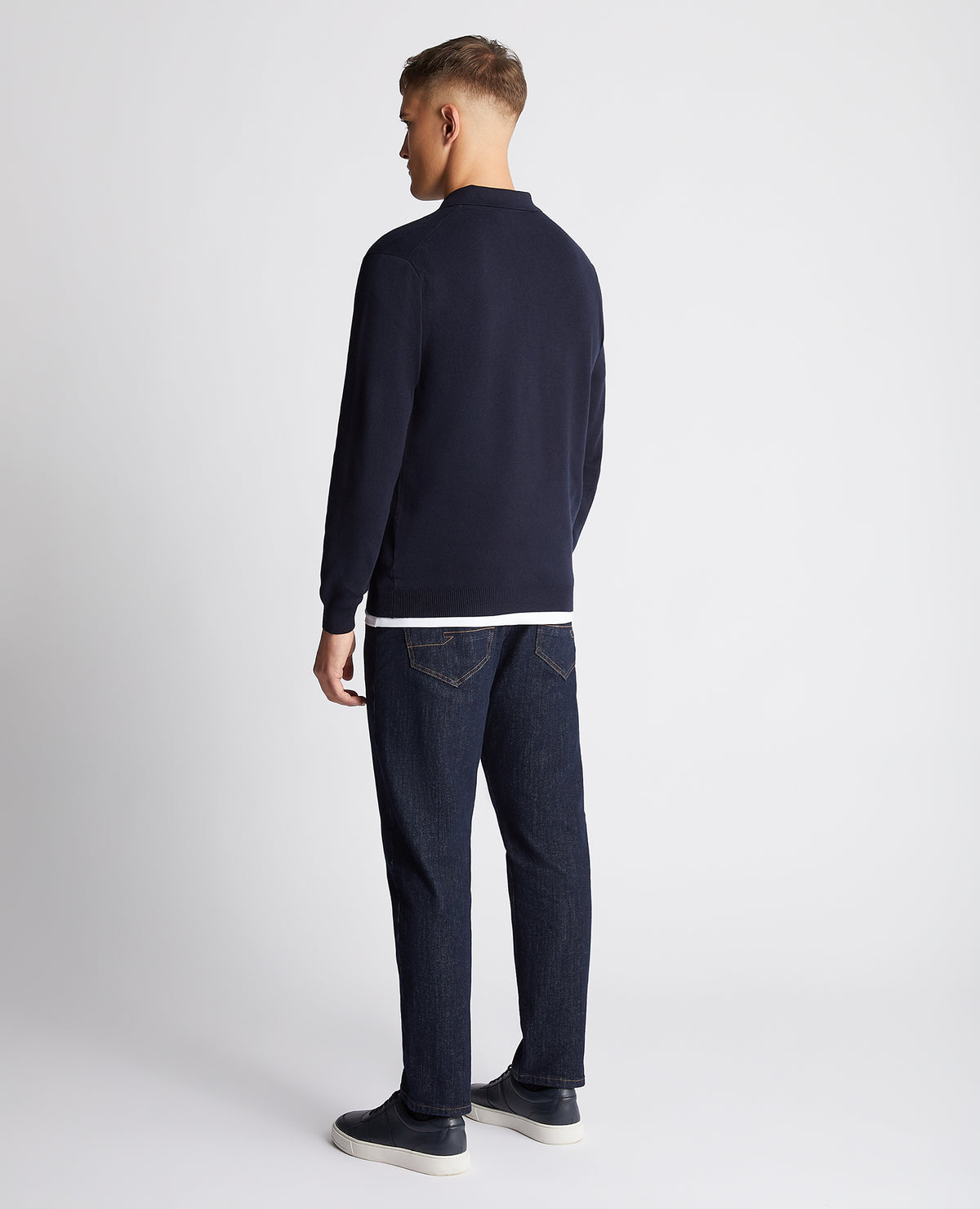 Man wearing a navy Relaxed Fit Long Sleeve Polo