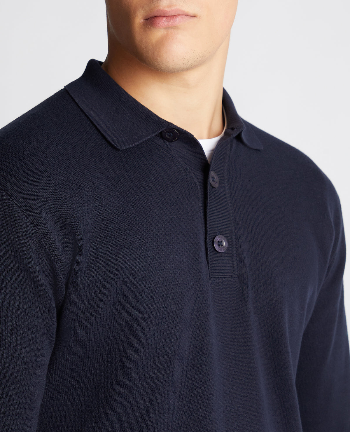 Man wearing a navy Relaxed Fit Long Sleeve Polo
