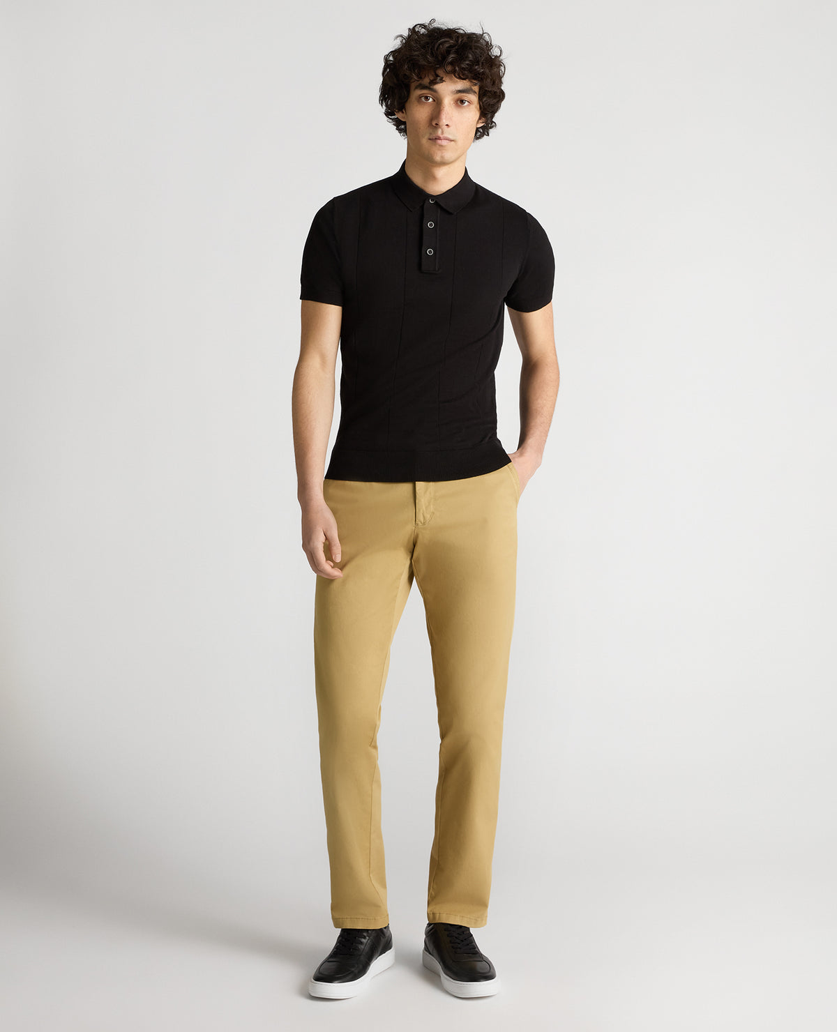 Man wearing a black Slim Fit Knitted Cotton Short-Sleeve Polo