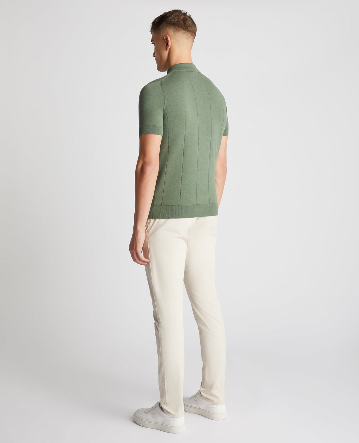 Man wearing a green Slim Fit Knitted Cotton Short-Sleeve Polo