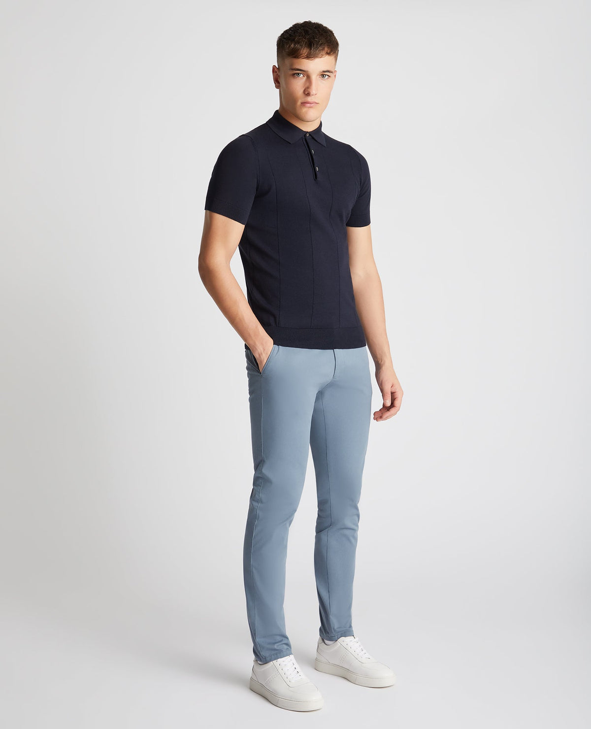 Man wearing a navy Slim Fit Knitted Cotton Short-Sleeve Polo