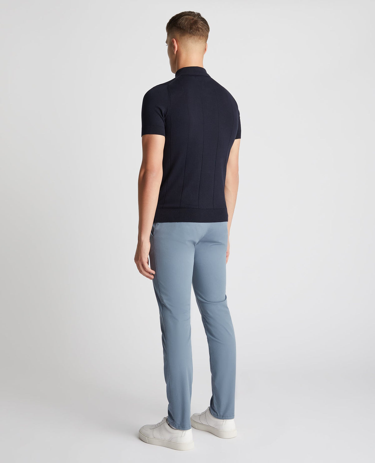 Man wearing a navy Slim Fit Knitted Cotton Short-Sleeve Polo