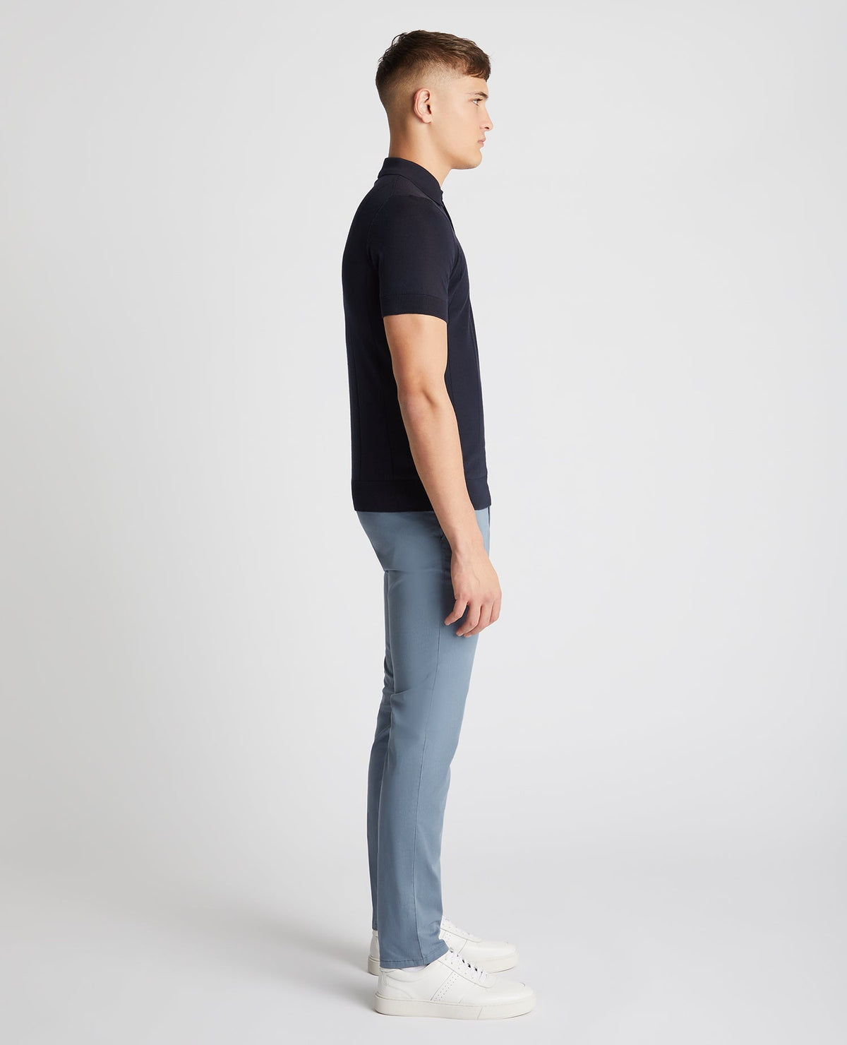 Man wearing a navy Slim Fit Knitted Cotton Short-Sleeve Polo