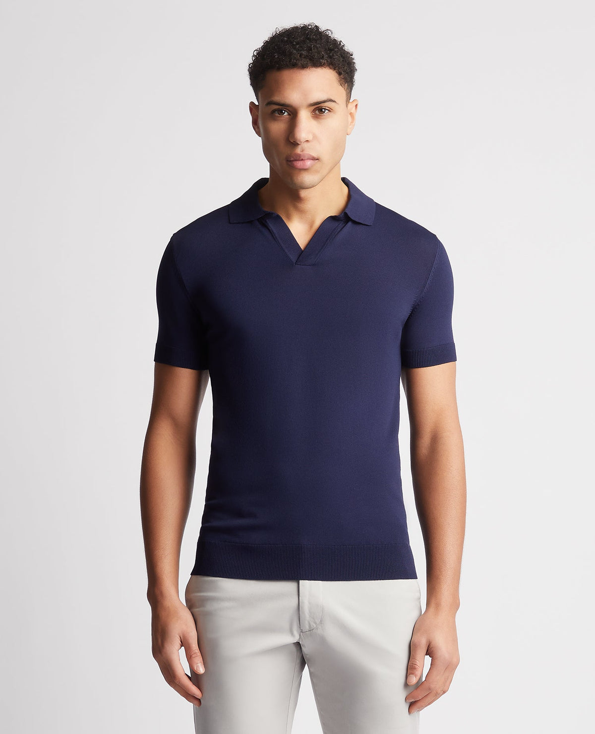 Man wearing a navy Knitted Short-Sleeve Polo