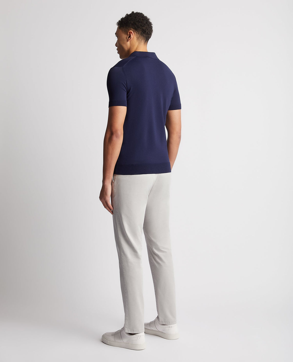 Man wearing a navy Knitted Short-Sleeve Polo