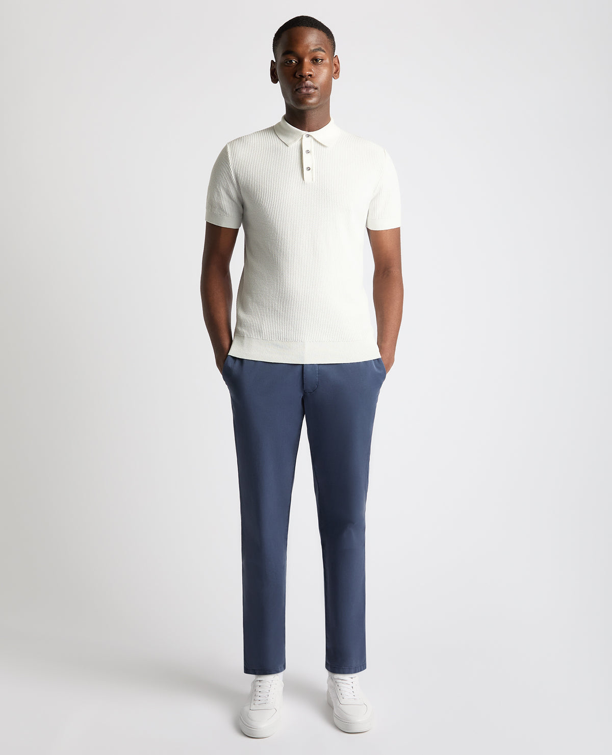 Man wearing a white Slim Fit Cotton Interest Fabric Polo Shirt